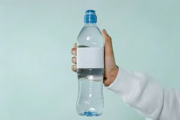 Empty reusable water bottle next to airplane window