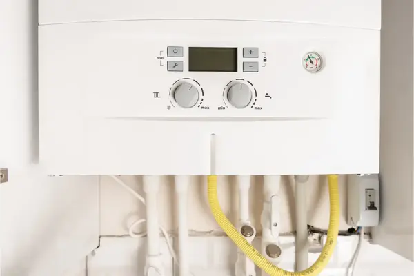 Hot water heater with thermostat dial showing temperature settings